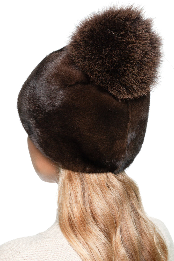 Back view of women’s brown mink fur beanie with large fox fur pom pom, luxury handmade winter hat ideal for skiing, city wear, and gifting.