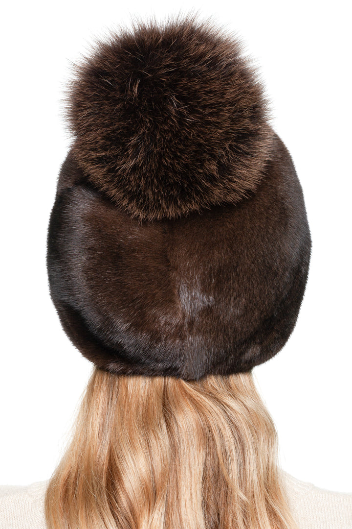 Close-up of back of brown mink fur hat with matching fox fur pom pom, elegant handmade real fur winter beanie for women.