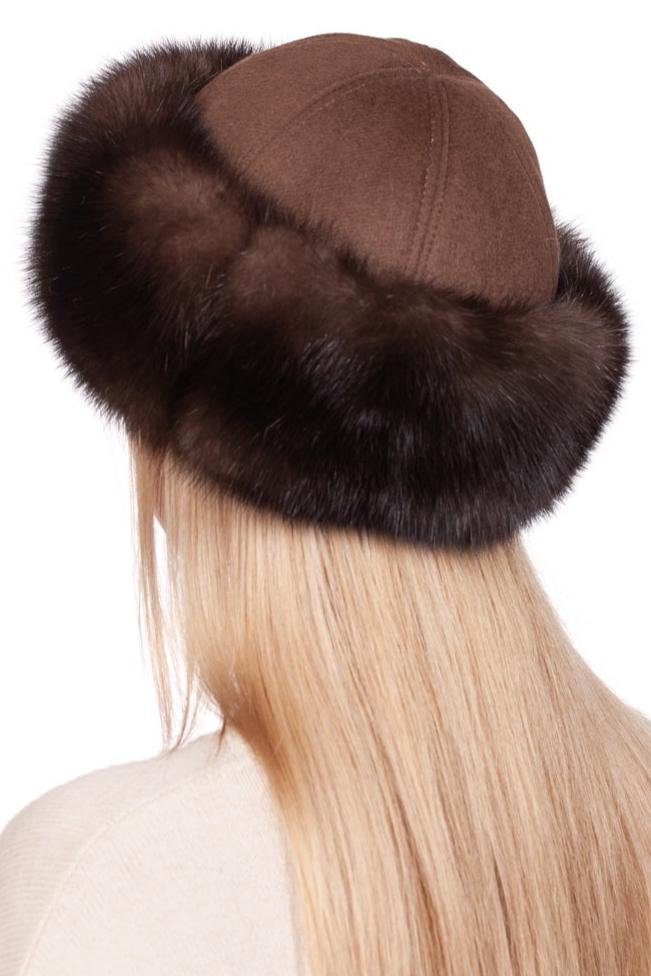 A person with long blonde hair is wearing a Brown Sable Fur Roller Hat With Cashmere from FurbySD, trimmed with thick, dark Barguzin sable fur. The emphasis is on the elegant hat and flowing hair against a plain white background.