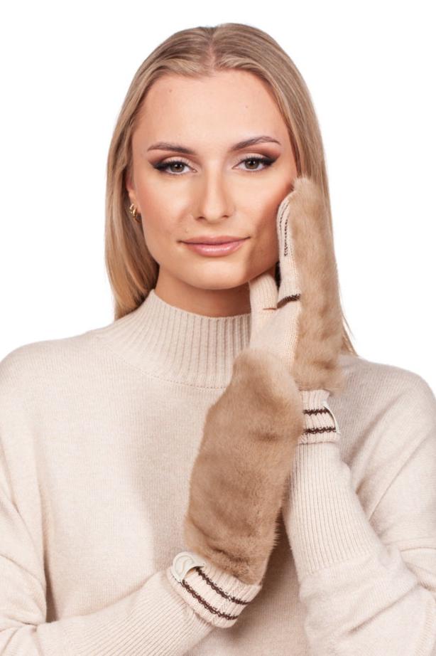 A person with long blonde hair wearing a light beige sweater and cozy Beige Flip Top Mink Fur Mittens by FurbySD smiles softly, gently holding one mittened hand to their cheek. The plain white background highlights this perfect winter accessory.