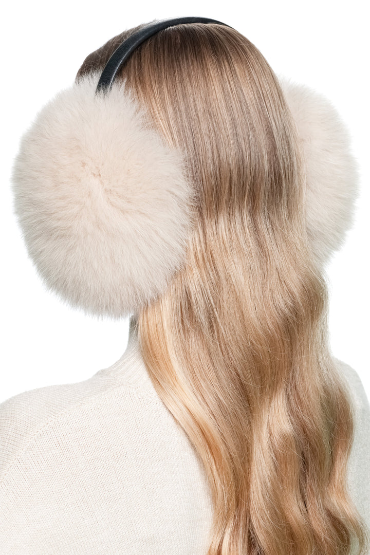 Overhead back angle of beige fox fur earmuffs with leather band – handmade luxury real fur winter accessory for women.