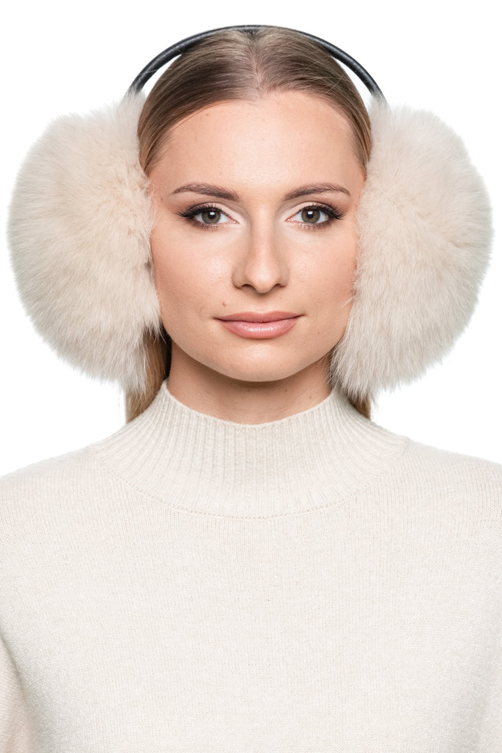 Front portrait of woman wearing beige fox fur earmuffs with leather band – soft fluffy winter ear warmers, Christmas gift idea.