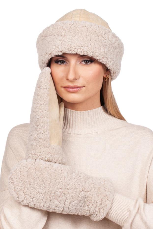 Dressed in a comfy cream ensemble, the individual showcases the Beige Shearling Fur Hat and Mittens Set by FurbySD. One mitten softly touches their face, and their long, straight hair flows from beneath the matching hat, perfectly embodying winter fashion accessories.