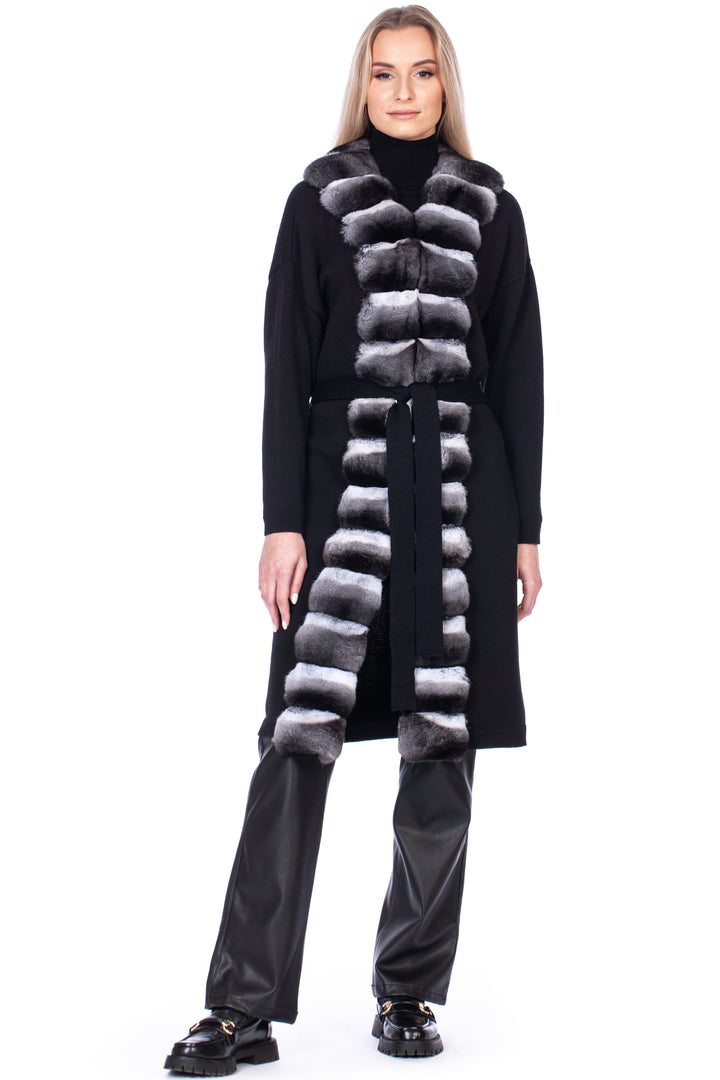 A model dressed in a FurbySD Chinchilla Fur Trimmed Cashmere Coat layered over a black turtleneck and black leather pants, posing against a white background.