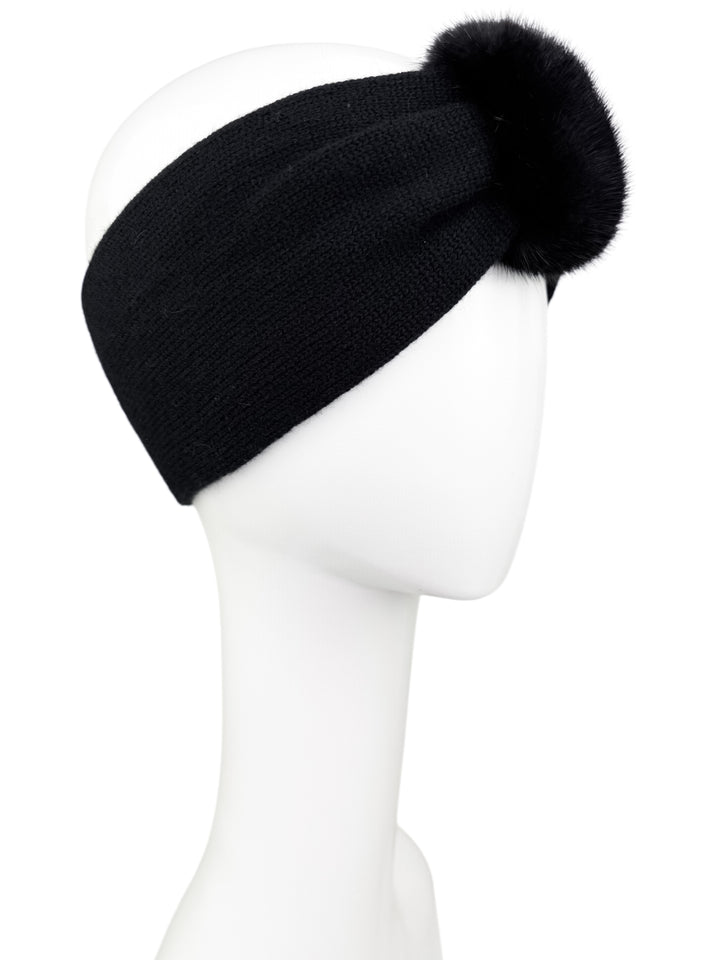 Black knitted cashmere headband with real mink fur detail, warm stylish winter ear band photographed from the left side.