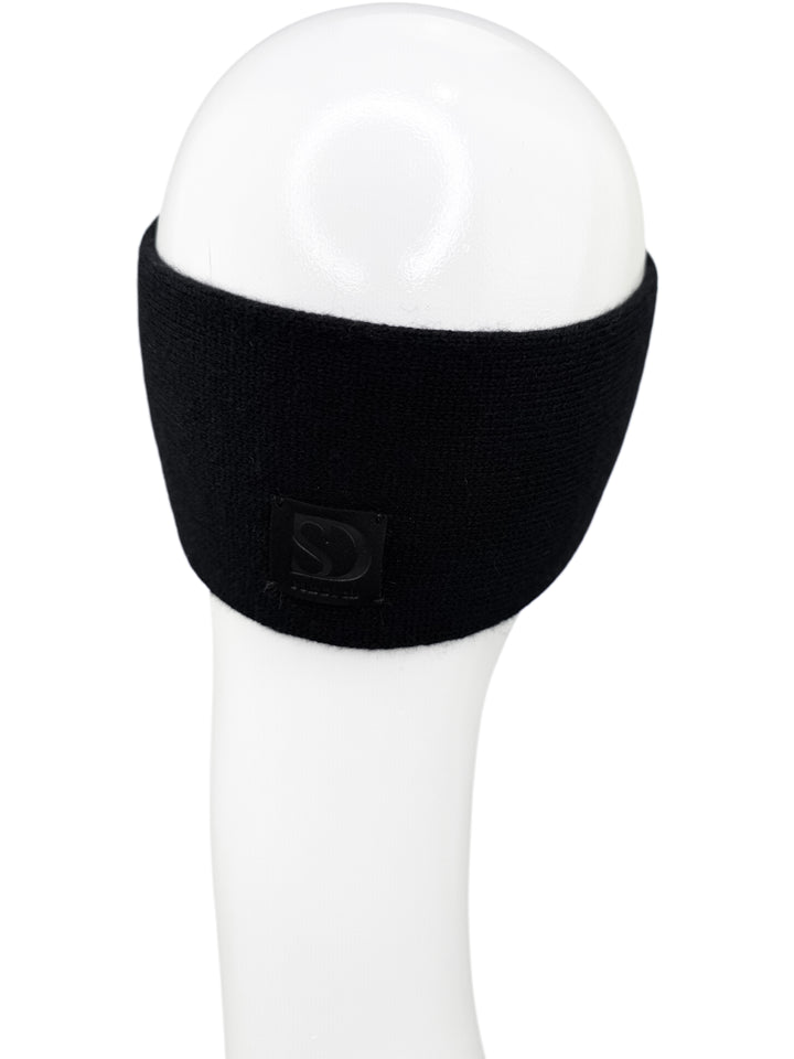 Black cashmere and merino wool headband photographed from back-left angle, soft warm winter ear warmer for women.