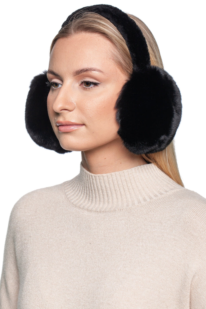 A person wearing FurbySD's Black Chinchilla Fur Earmuffs with Astrakhan Band and a beige turtleneck sweater looks to the side. Their long hair is down, set against a plain white background.