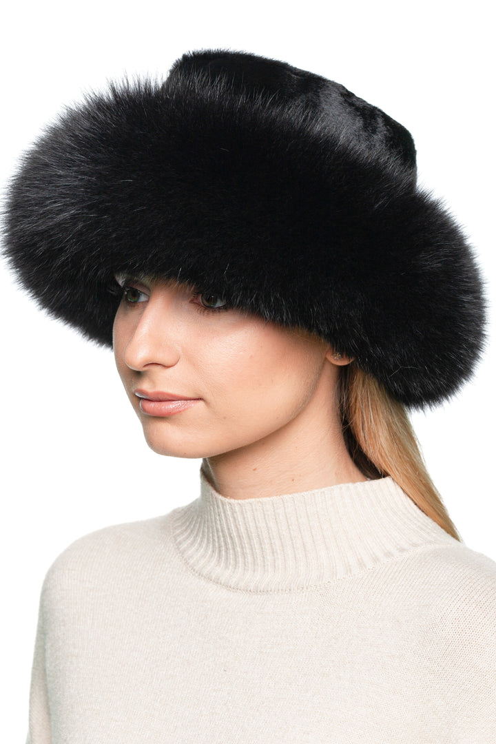 Woman wearing a Black Fox Fur Panama Hat, showcasing its luxurious style and warm, wide fur brim.