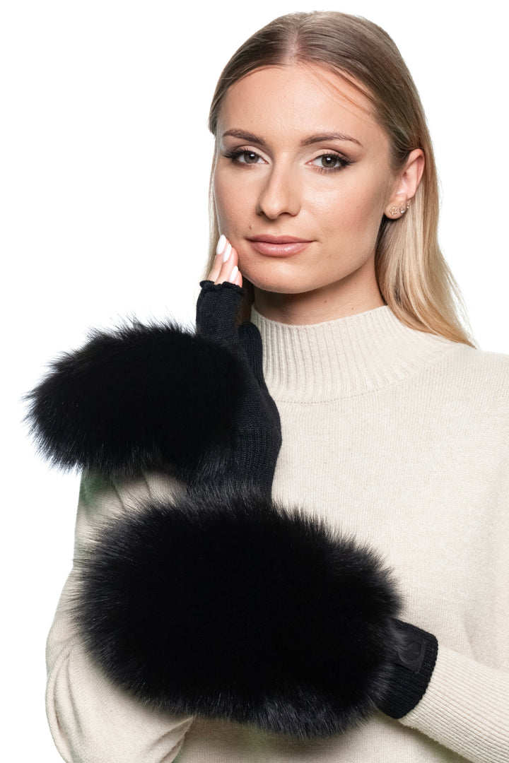 Woman wearing handmade black fox fur flip top mittens, convertible winter gloves with real SAGA-certified fox fur trim and merino wool knit, luxury cold weather accessory.