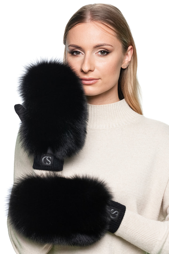 Close-up of luxury black fox fur mittens with flip-top design, fingerless wool gloves for women, fluffy real fur trim for warmth and style in winter.