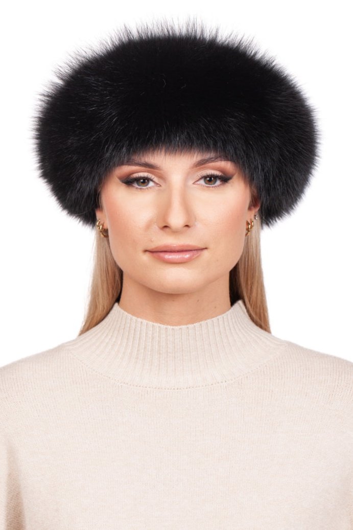 A person wearing a beige turtleneck sweater and the elegant Black Fox Fur Headband by FurbySD, showcasing genuine fox fur accents with a luxurious cashmere lining, poses gracefully against a white background.