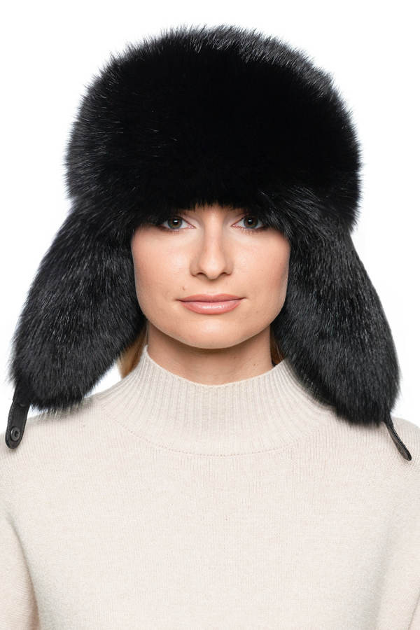Front view of black fox fur ushanka hat with fluffy earflaps, warm real fur bomber cap for winter fashion, unisex Russian trapper ski hat.