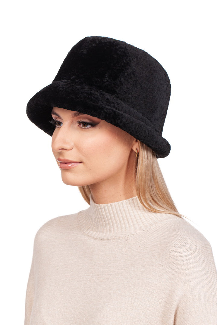 A person with long blonde hair is wearing a FurbySD Black Sheepskin Hat With a Brim and a cream-colored turtleneck sweater. The background is white.