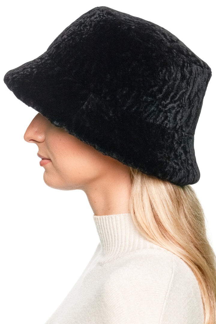 Side view of real black sheepskin bucket hat, warm lamb fur cap with classic fisherman silhouette, unisex winter fashion accessory.