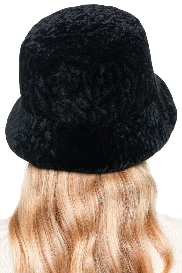 Rear view of black sheepskin bucket hat, classic lamb fur winter headwear with retro fisherman cap design for men and women.