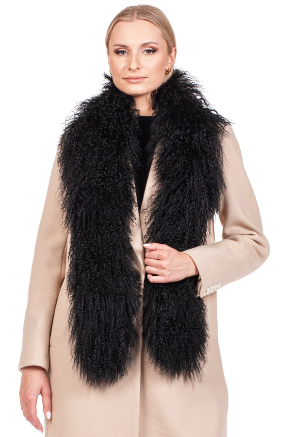 Elegant woman modeling a long Black Mongolian Lamb Fur Scarf over a beige coat, showcasing its luxurious texture.