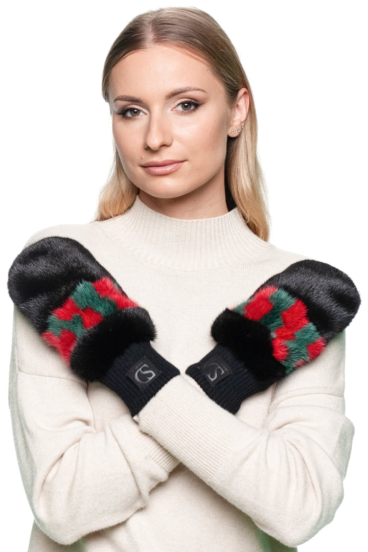 Woman posing with black mink fur mittens, flip top style showing red and green details.