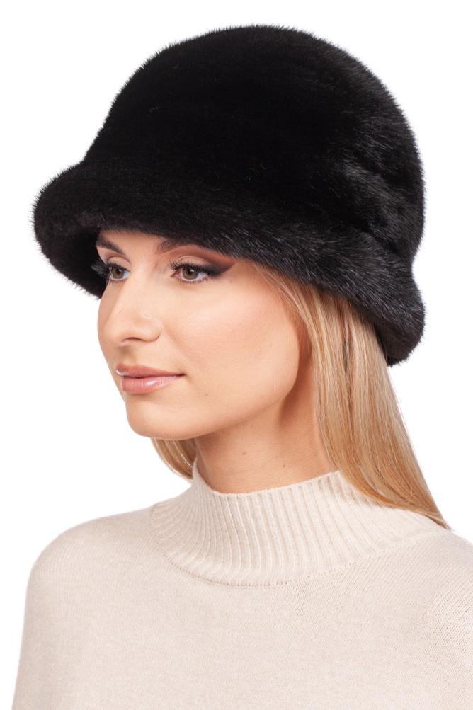 A person with long blonde hair is wearing a luxurious Black Mink Fur Bucket Hat by FurbySD and a cream turtleneck sweater. The white background accentuates this elegant fashion accessory.