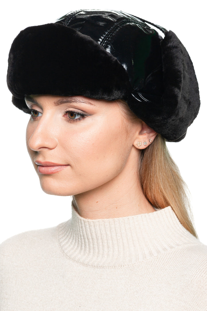 Side angle of black leather winter trapper hat with mouton fur lining – elegant women’s fur earflap hat designed for extreme cold protection and chic city looks.