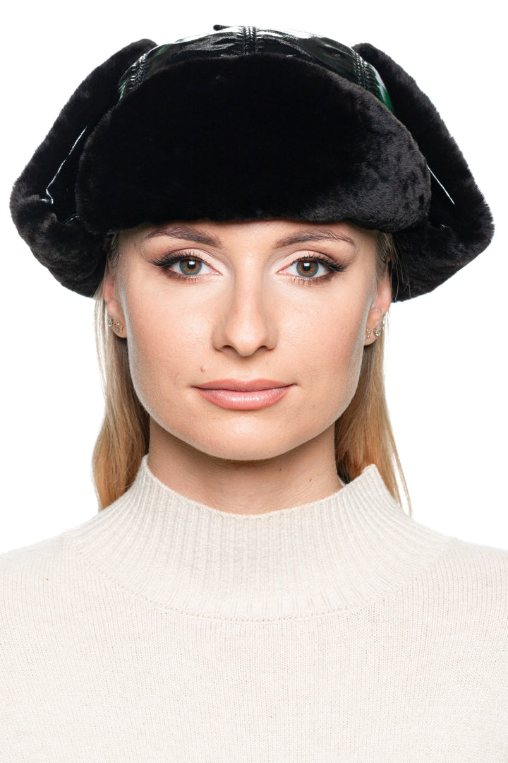 Front view of black mouton fur earflap hat for women – glossy black leather winter hat with soft shearling inside, perfect for skiing, après-ski, and urban wear.