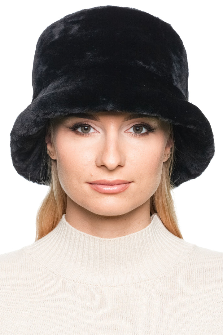 Woman wearing Black Mouton Lamb Fur Bucket Hat, plush lamb wool winter hat with structured brim, luxury handmade fashion accessory.
