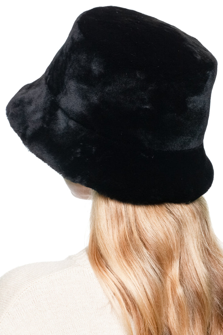 Back profile view of Black Mouton Lamb Fur Bucket Hat, real lamb fur plush winter hat, luxury slow fashion accessory for women.