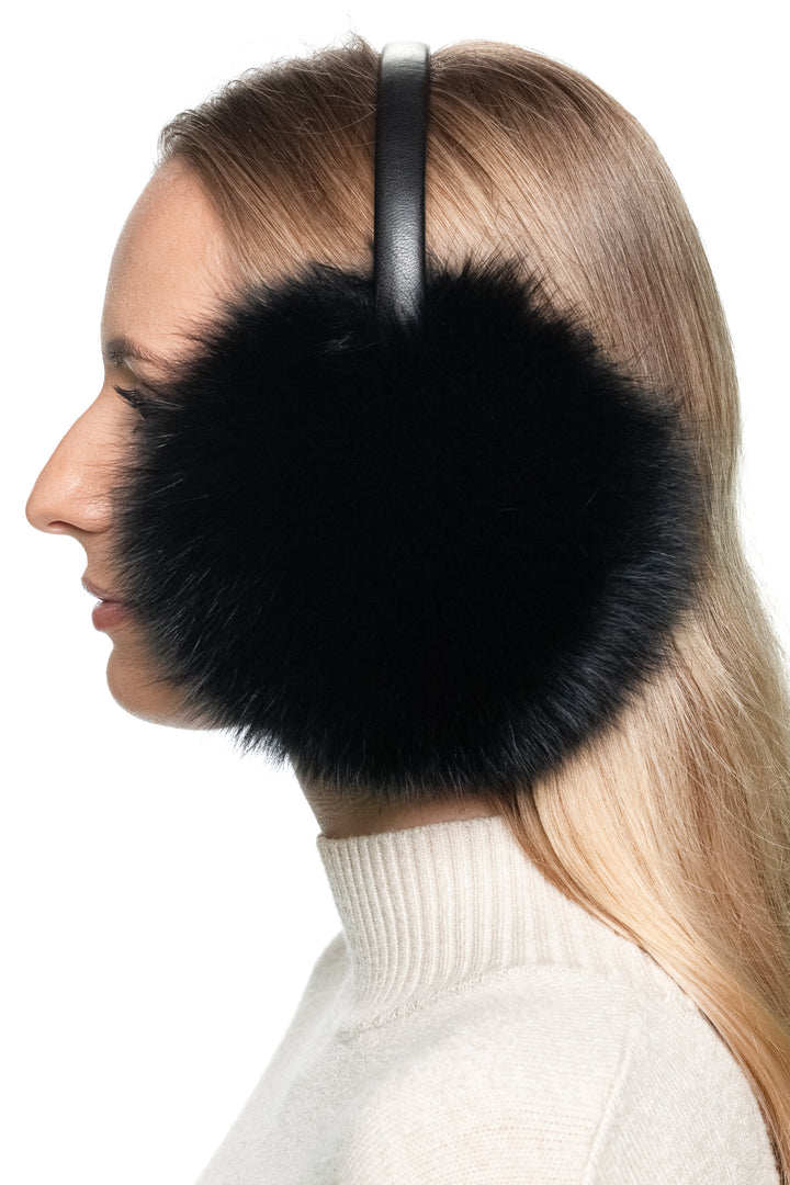 Profile of woman wearing black fox fur earmuffs, cosy real fur ear warmers with adjustable leather headband.