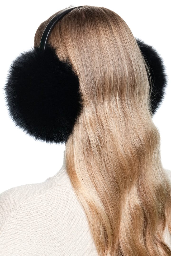 Rear view of fluffy black fox fur earmuffs with leather band, warm winter accessory and luxury gift for her.
