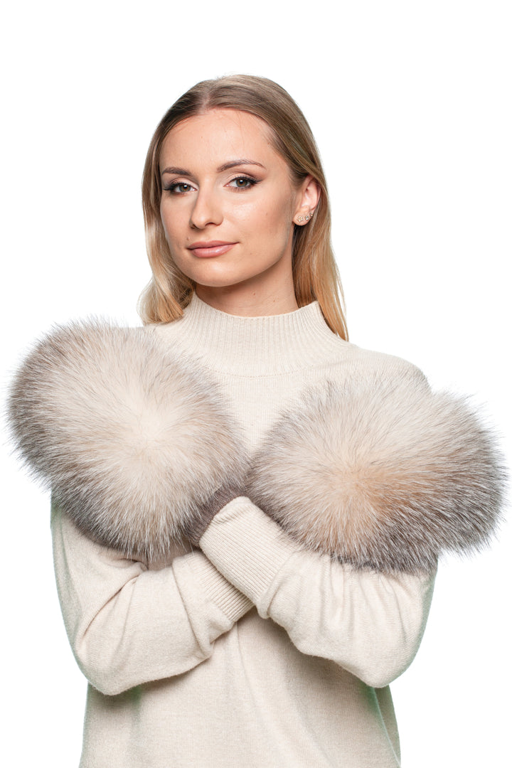 Woman wearing a cream sweater with handmade ethically sourced fox fur and merino wool mittens on a white background