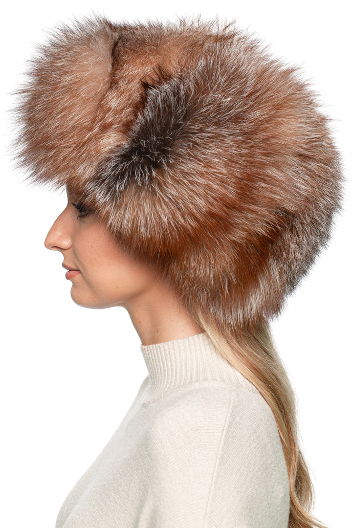 Side view of Brown Amber Frost Fox Fur Trapper Hat on woman – oversized full fur ushanka hat with earflaps, handmade winter luxury hat for warmth and style.
