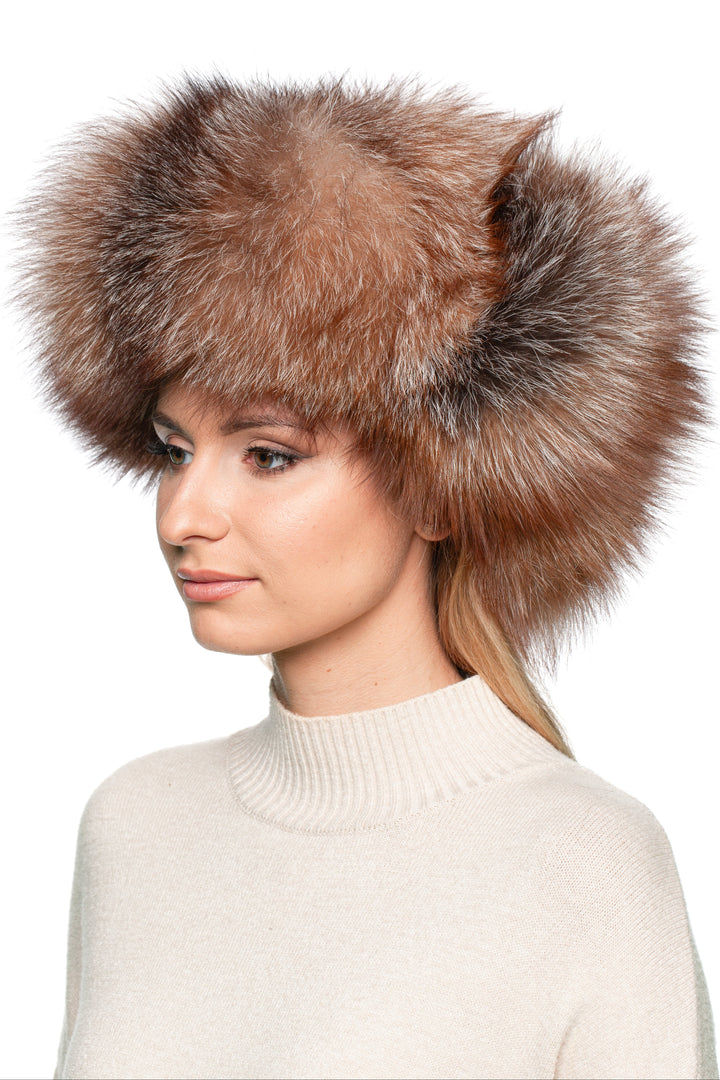 Profile of woman wearing Brown Amber Frost Fox Ushanka Hat – real fur trapper hat with rich amber and silver tones, oversized earflaps for windproof winter wear.