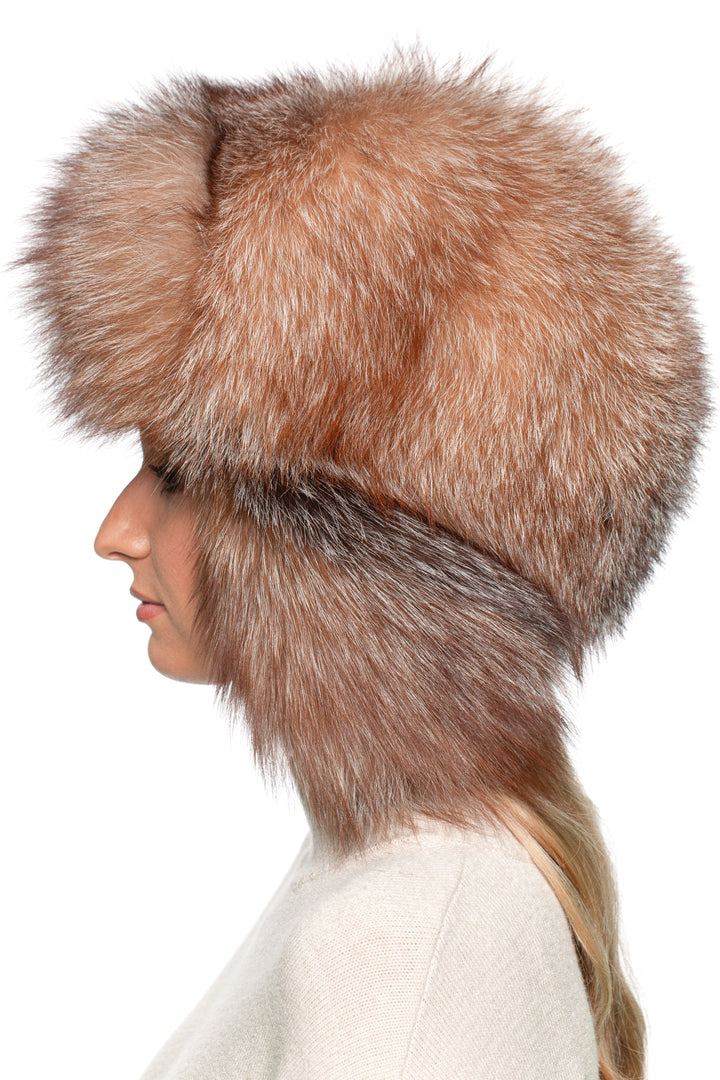 Three-quarter side view of Frost Fox Fur Trapper Hat – brown amber full fur ushanka with long earflaps, handmade luxury winter hat.