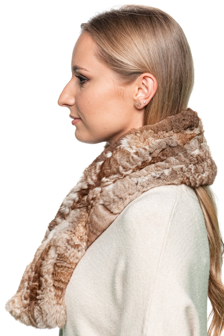 Angled view of a woman wearing a brown chinchilla fur knitted scarf, highlighting the scarf’s soft pattern, shine, and plush texture.