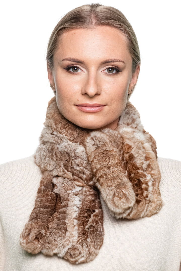 Woman wearing a brown chinchilla fur scarf styled in a single loop around the neck, creating a warm, elegant winter look.