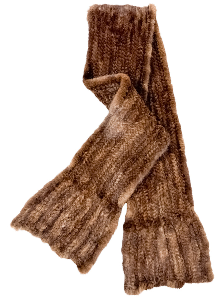 Introducing the Brown Knitted Mink Fur Scarf by FurbySD, a luxurious accessory featuring a long, textured design with wide, ribbed ends. Crafted from ethically sourced mink fur, this scarf boasts a soft and warm fabric that flows elegantly, providing both comfort and sophistication.