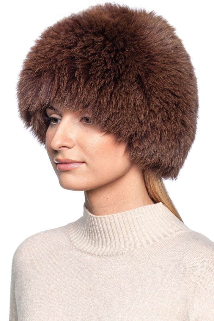 Brown fox fur knit beanie hat model wearing, showcasing luxurious warmth and elegant design for winter.