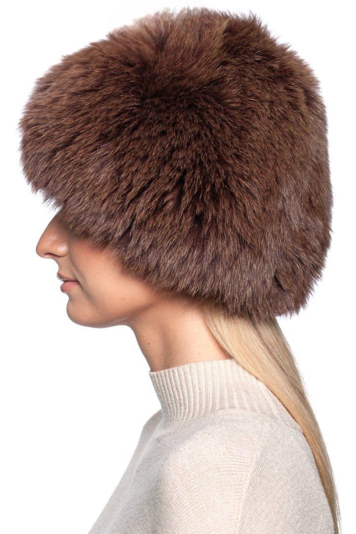 Brown fox fur knit beanie hat shown on a model, showcasing its luxurious texture and warm design for winter fashion.