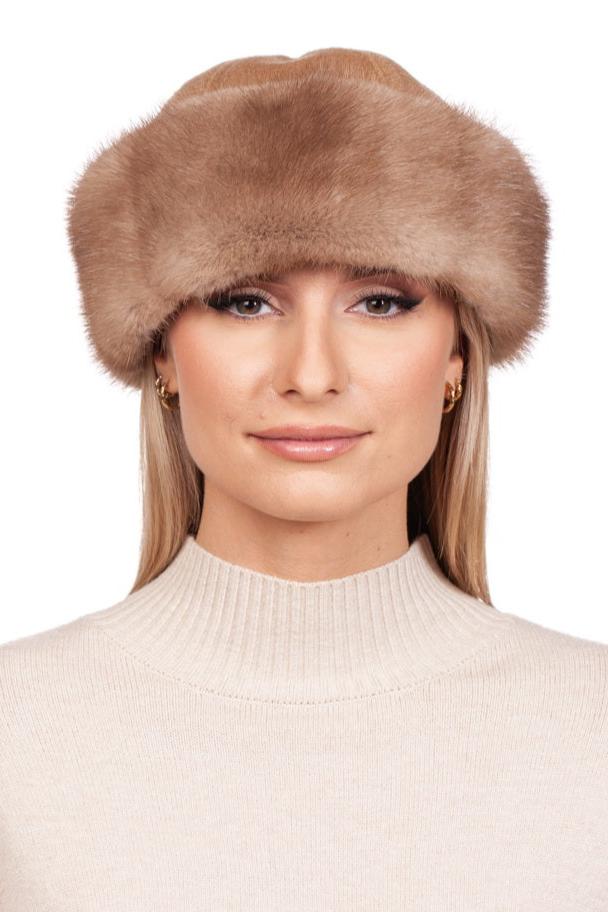 A person with long blonde hair wears a beige turtleneck sweater complemented by luxury winter accessories from FurbySD, including the Beige Mink Fur Hat and Flip Top Mittens Set. The background is white.