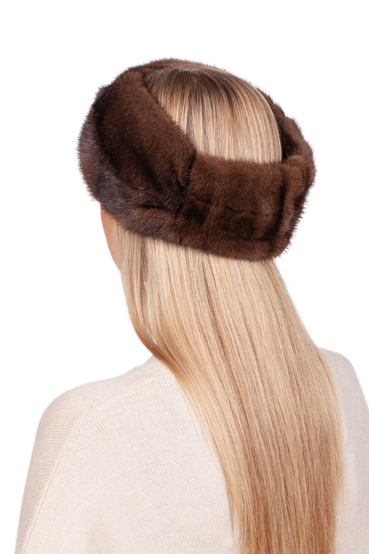 A person with long blonde hair is seen from the back wearing a handcrafted Brown Mink Fur Headband by FurbySD. The outfit consists of a light beige top that complements the genuine mink fur accessory. The background is plain white.