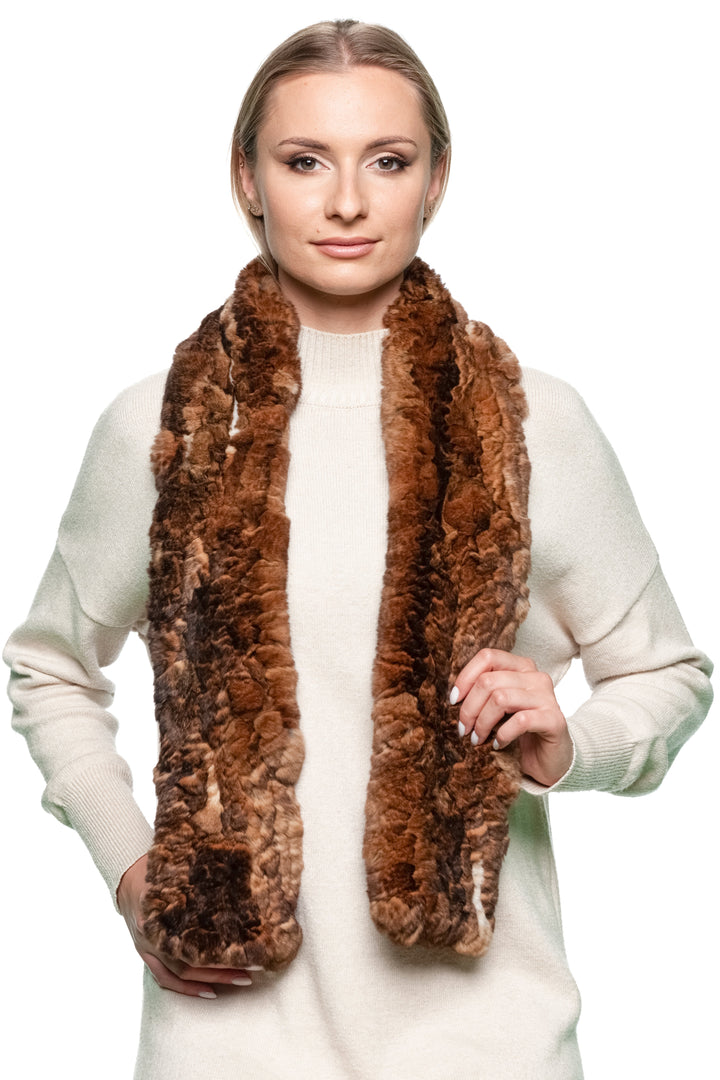 Woman wearing a long brown rex rabbit fur knitted scarf, handmade from real soft fur, styled over a cream sweater — luxury winter scarf for women.