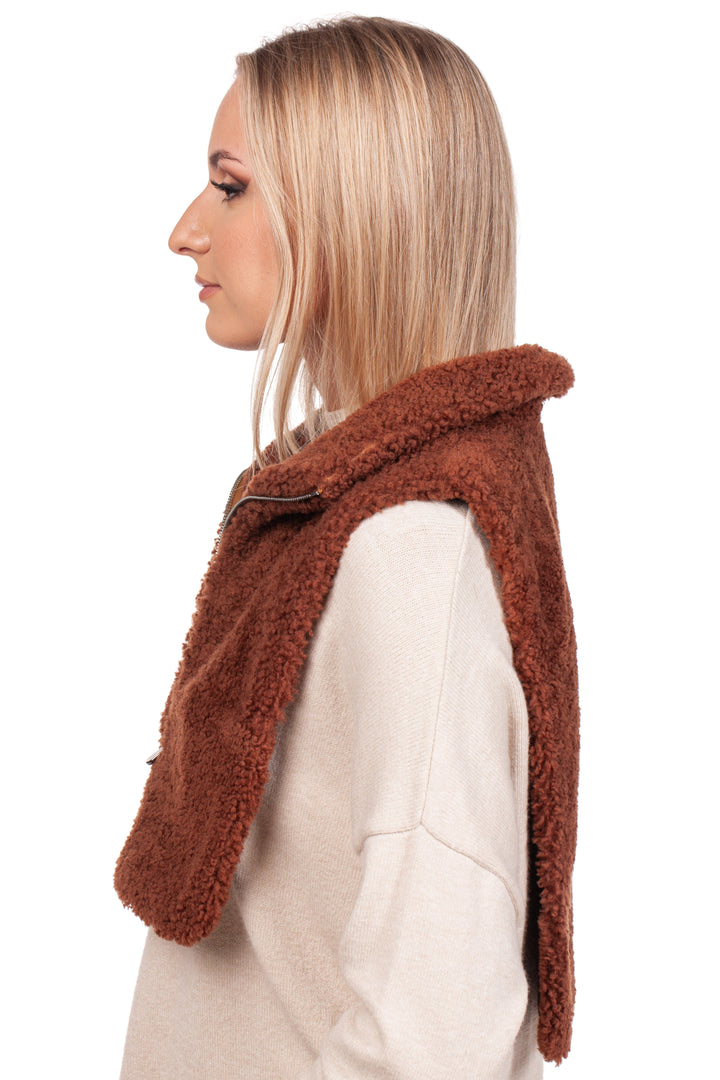 A woman with long blonde hair is wearing a light beige sweater and a brown, woolly shawl. She also sports the Brown Shearling Fur Turtleneck Collar by FurbySD, enhancing her elegant side profile against the white background.