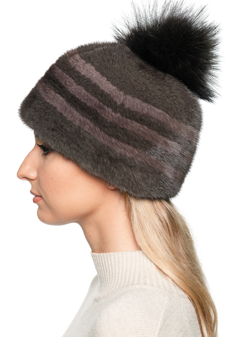 Elegant striped mink fur hat with fluffy fox fur bobble – luxury handmade winter beanie for women, outdoor après-ski style.