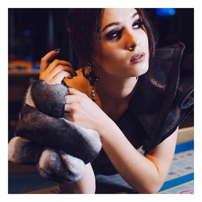 Chinchilla fur clutch styled with a coat