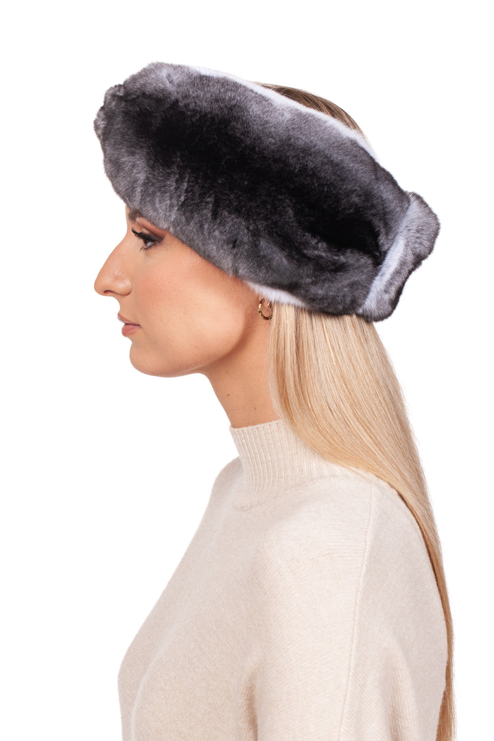 A person with long blonde hair models the chic Twisted Chinchilla Fur Headband by FurbySD in luxurious gray and pairs it perfectly with a cream sweater, all set against a simple white background.