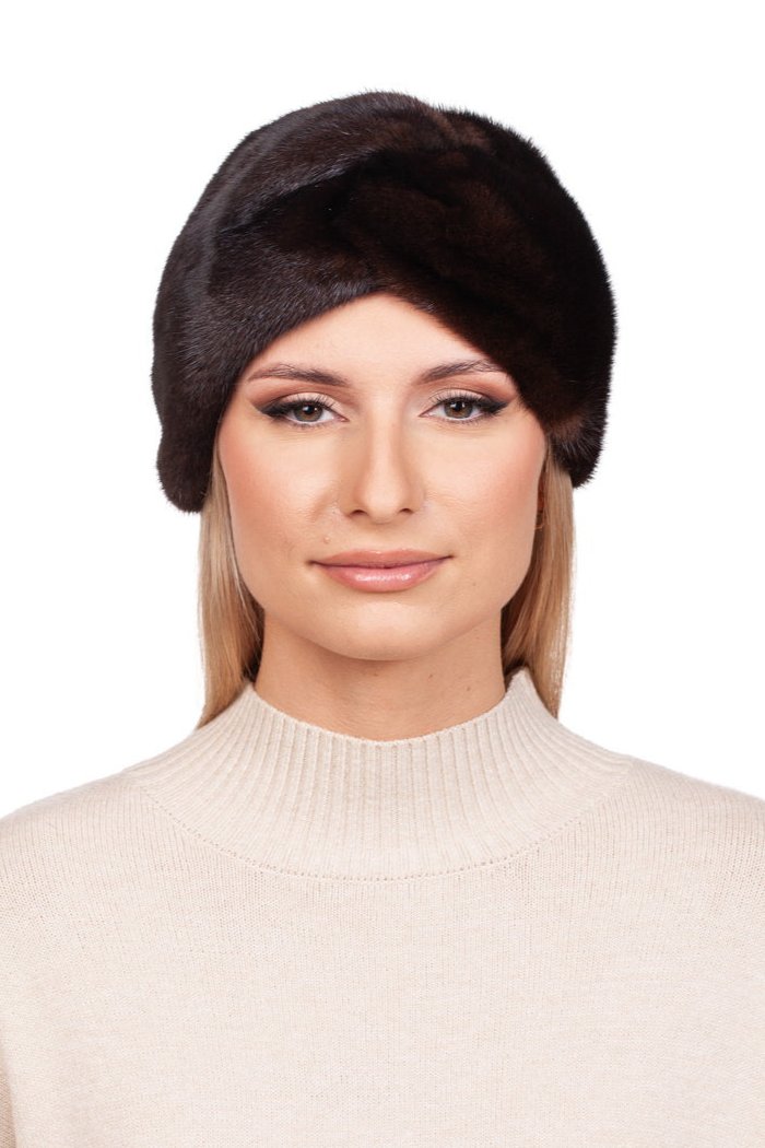 A person with long hair wears a FurbySD Dark Brown Mink Fur Headband, paired with a light beige turtleneck sweater. The cashmere lining provides additional warmth, and their outfit stands out against the plain white background.