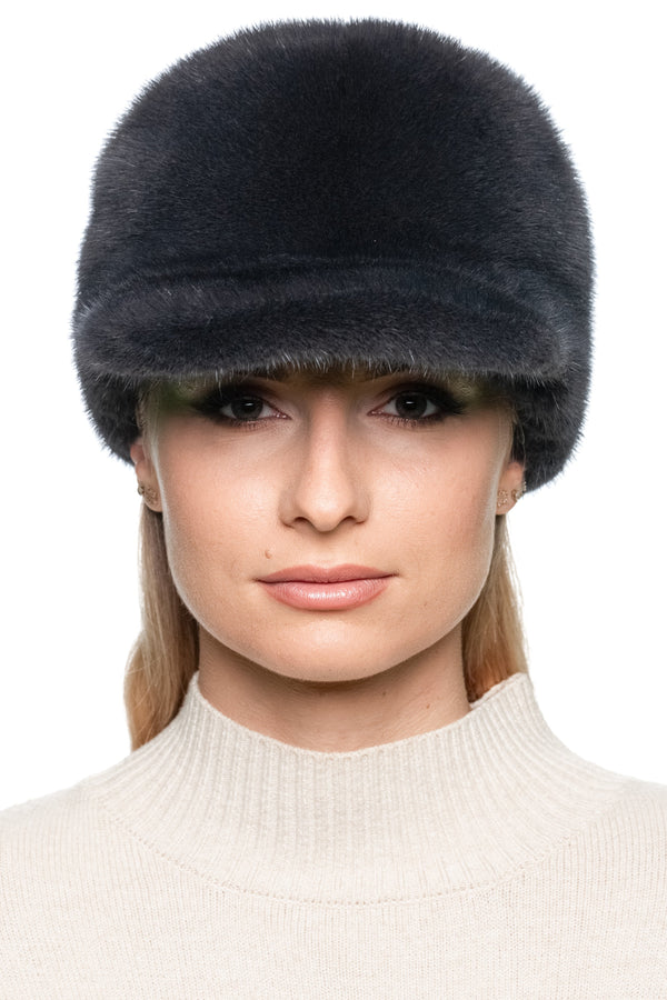 Dark grey mink fur baseball cap, handmade winter hat with brim shown from the front on model, unisex adjustable luxury fur cap for cold weather fashion.