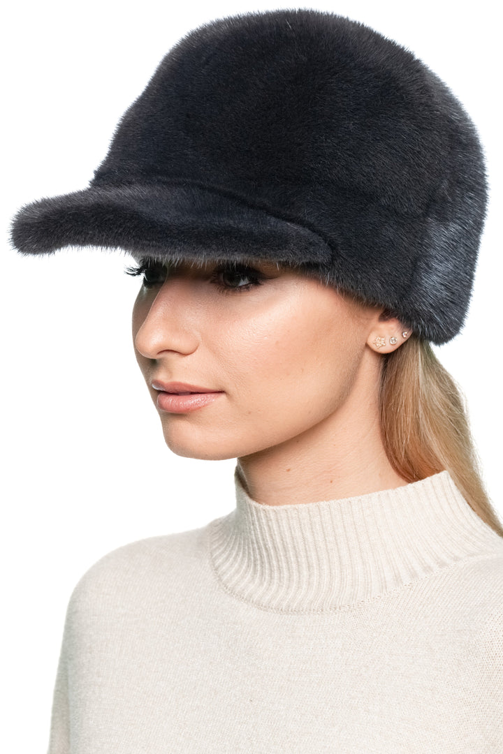Handmade dark grey mink fur baseball cap with structured brim, unisex winter trucker hat shown at side angle on model, adjustable one-size design.