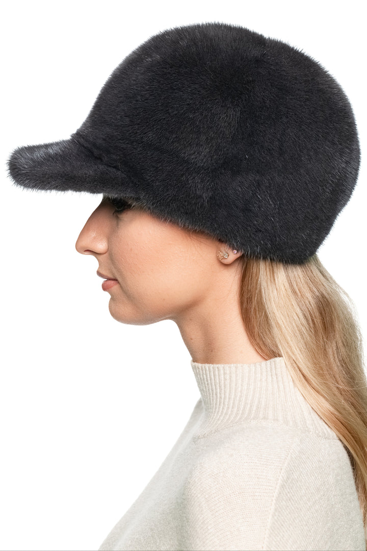 Profile view of luxury dark grey mink fur baseball cap, handmade winter hat with brim for men and women, soft real fur cap in sporty trucker style.
