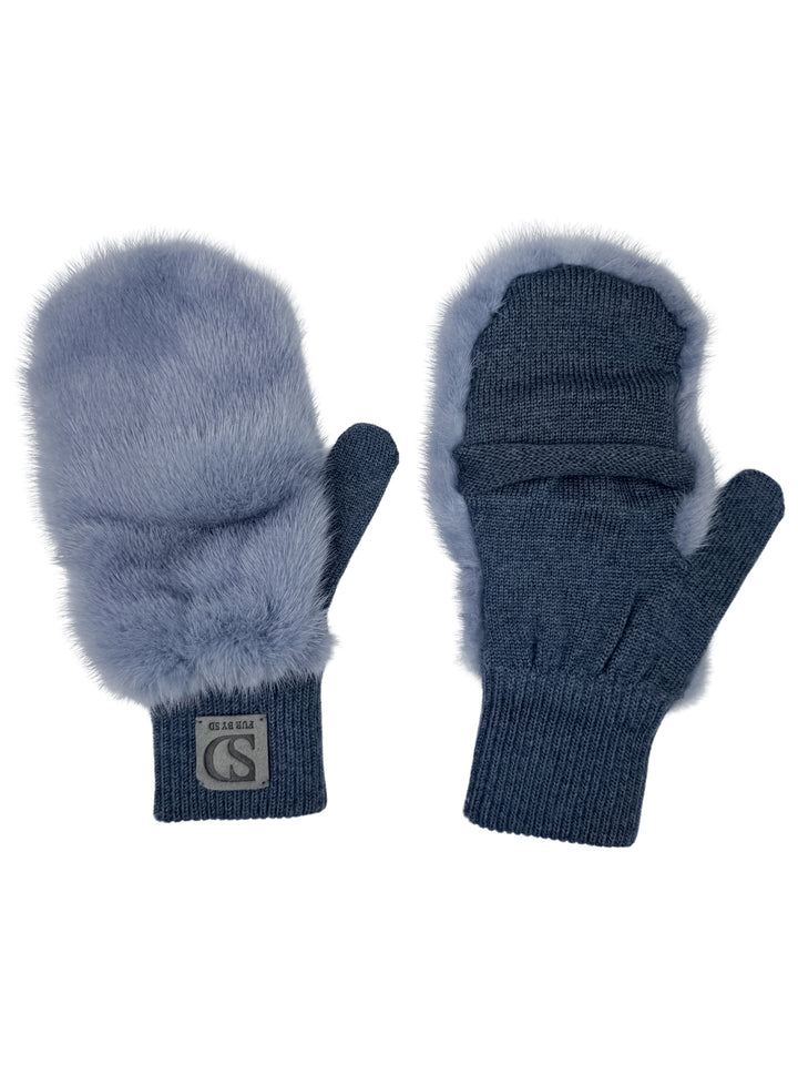 Introducing the Denim Blue Mink Fur Flip Top Mittens by FurbySD, these luxurious winter accessories feature mink fur accents and come in a rich denim blue. The left mitten showcases a label with lettering, while both mittens are designed with ribbed cuffs. A cozy appearance is achieved through the combination of knit fabric and a fluffy texture on the top side.