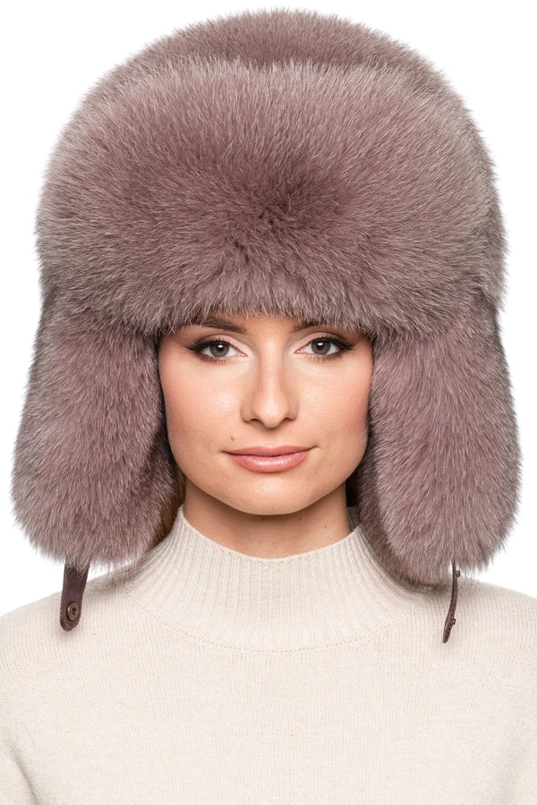 Luxury dusty pink fox fur trapper hat for women, oversized Russian ushanka style with plush earflaps and voluminous crown, warm winter fur fashion accessory.